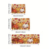 A decorative area rug featuring autumn pumpkins and maple leaves in warm earth tones.