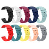 A variety of silicone watch bands in black, white, purple, blue, mint green, and orange colors displayed together.