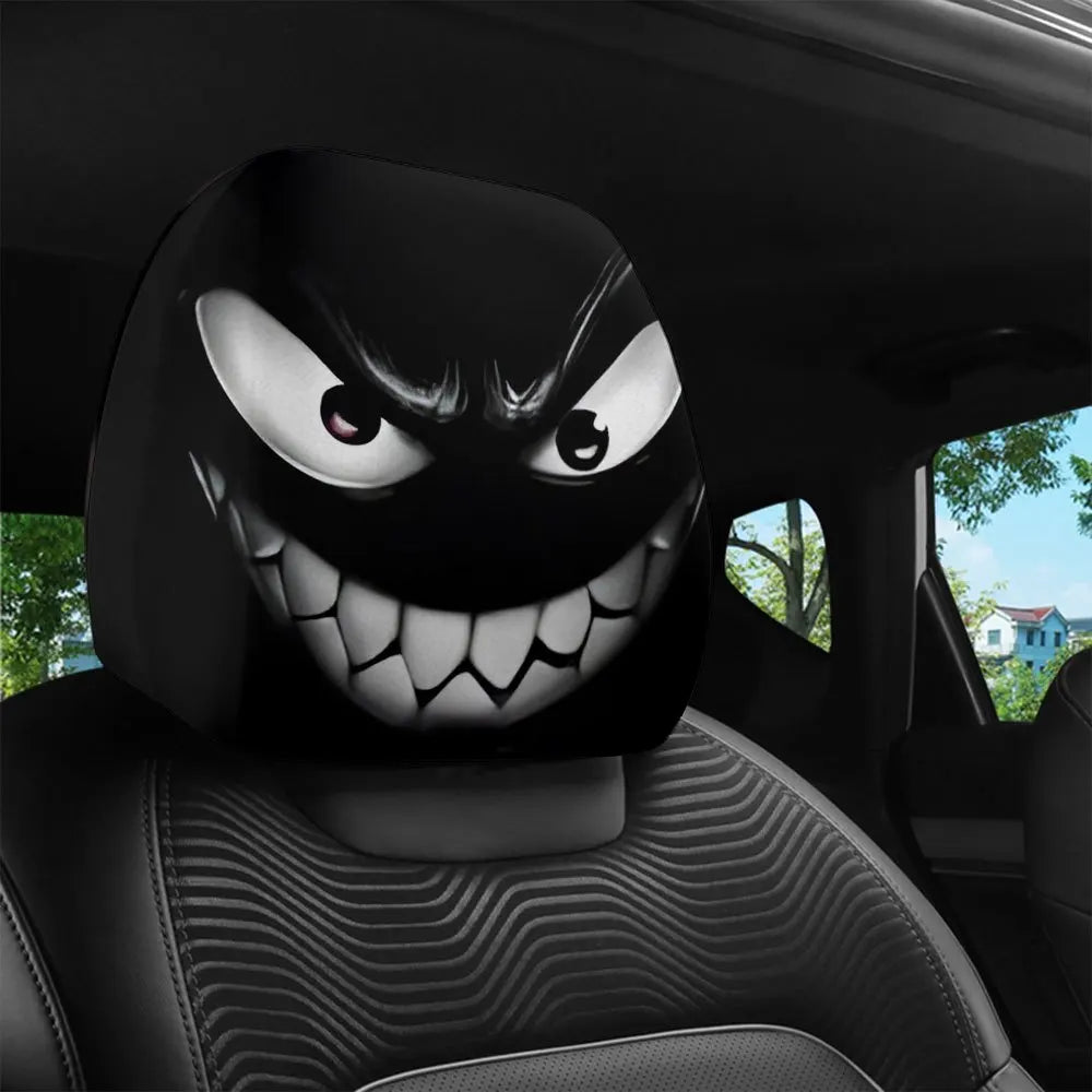A close-up view of a black and white Evil Grin car headrest cover with an aggressive grin design on a car seat.