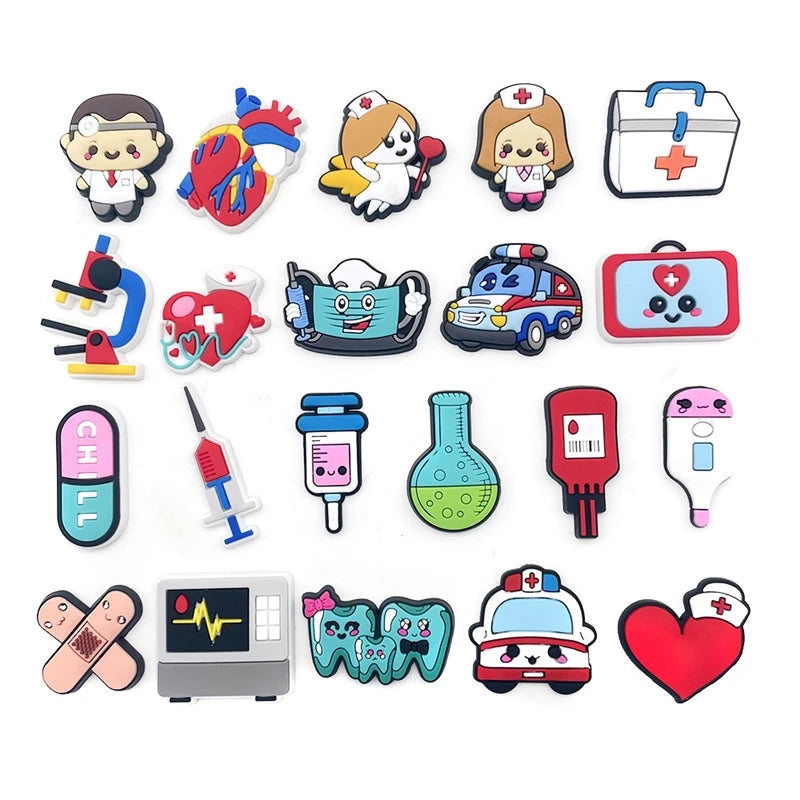 A collection of colorful PVC pins and charms featuring medical themes, including a heart, stethoscope, ambulance, and first a
