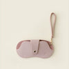 A pink PU leather glasses case with a retro lychee pattern and a thin strap.