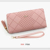 A pink quilted PU leather wristlet clutch wallet with a gold-toned strap and logo detail.
