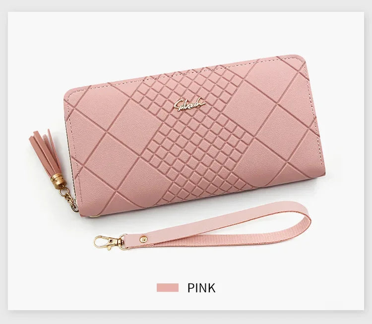 A pink quilted PU leather wristlet clutch wallet with a gold-toned strap and logo detail.