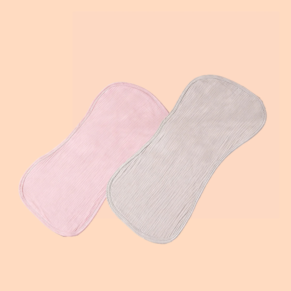 A pair of soft absorbent baby burp cloths, one pink and one light gray, are shown against a pale background.