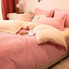 A pink flannel duvet cover with a zipper and light beige throw blanket on a bed.