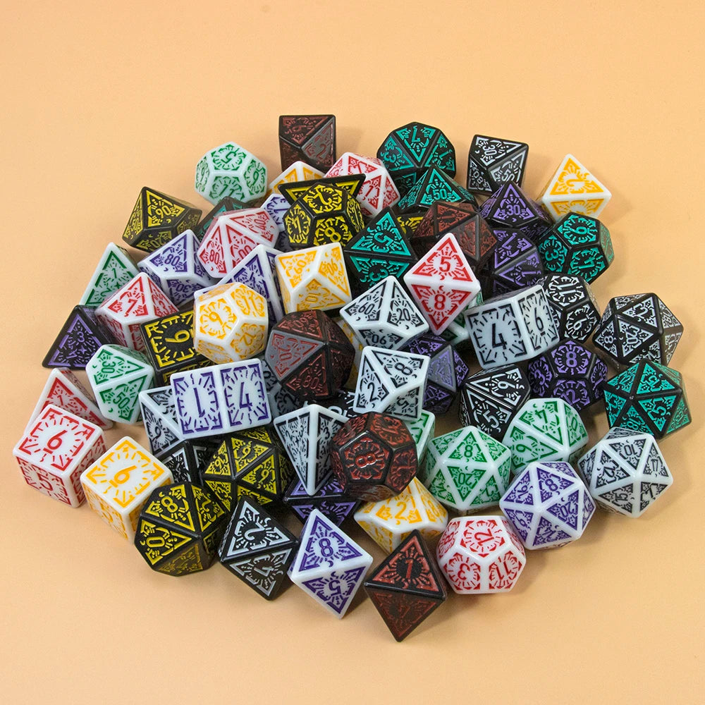 A collection of multi-sided polyhedral dice in various colors and shapes scattered on a light background.