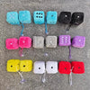 A collection of plush velvet dice in various colors including blue, black, pink, purple, and yellow.