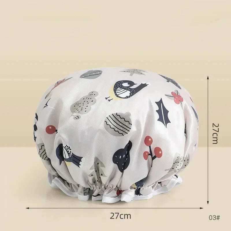 A reusable waterproof shower cap for hair care in a light beige fabric with various black and red animal patterns.