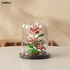 A clear glass dome display of a miniature eternal rose bouquet made from building blocks.