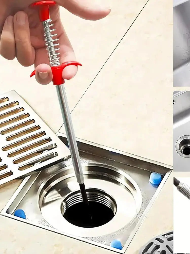 A hand is using a flexible drain snake with a red handle to clear a clog in a kitchen sink.