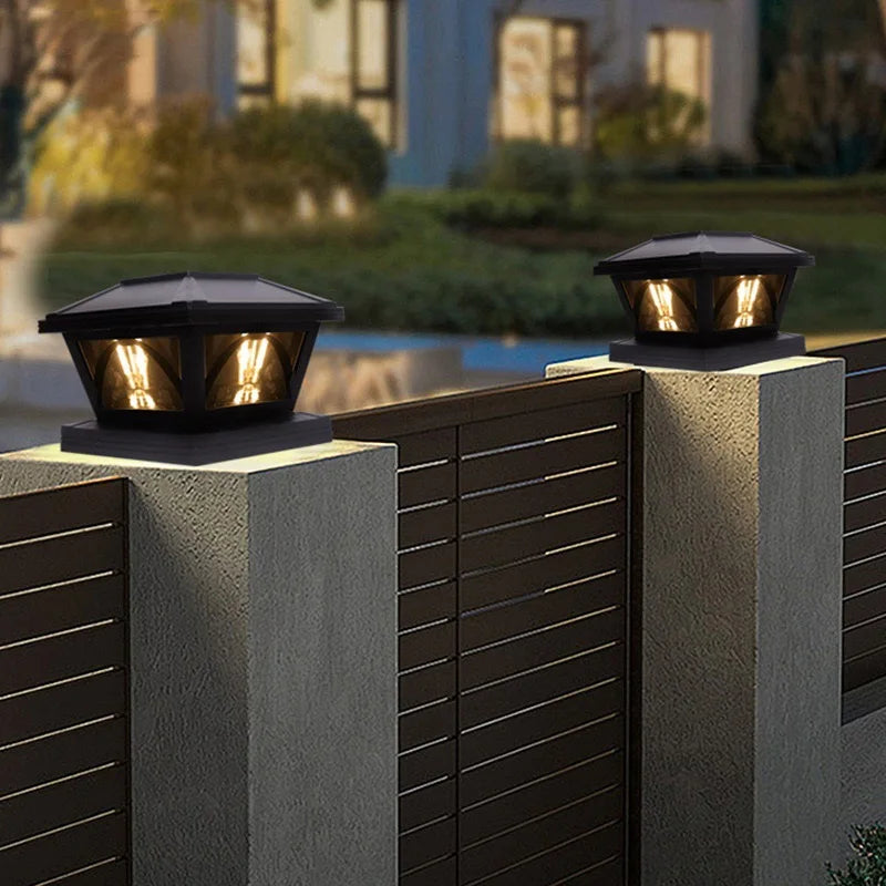 Outdoor solar post cap lights with warm LED illuminating a wooden fence and patio area.