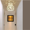 A crystal single-head ceiling lamp with a metal frame hangs in a bright hallway.
