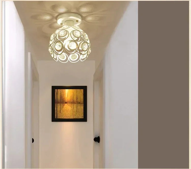 A crystal single-head ceiling lamp with a metal frame hangs in a bright hallway.