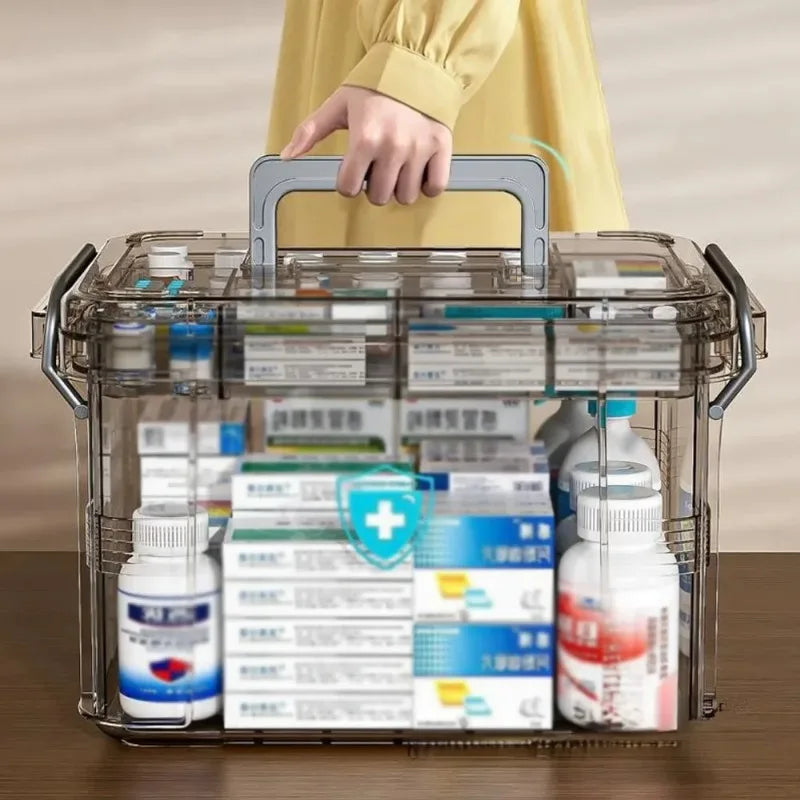 A transparent plastic first aid storage box with a handle filled with various medical supplies.