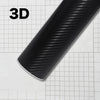 A close-up view of a black carbon fiber vinyl wrap film, showing its texture and finish on a grid background.