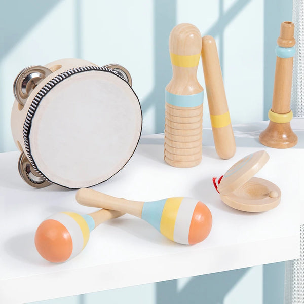 A set of wooden percussion instruments for kids including a drum, maracas, and shakers displayed on a white surface.