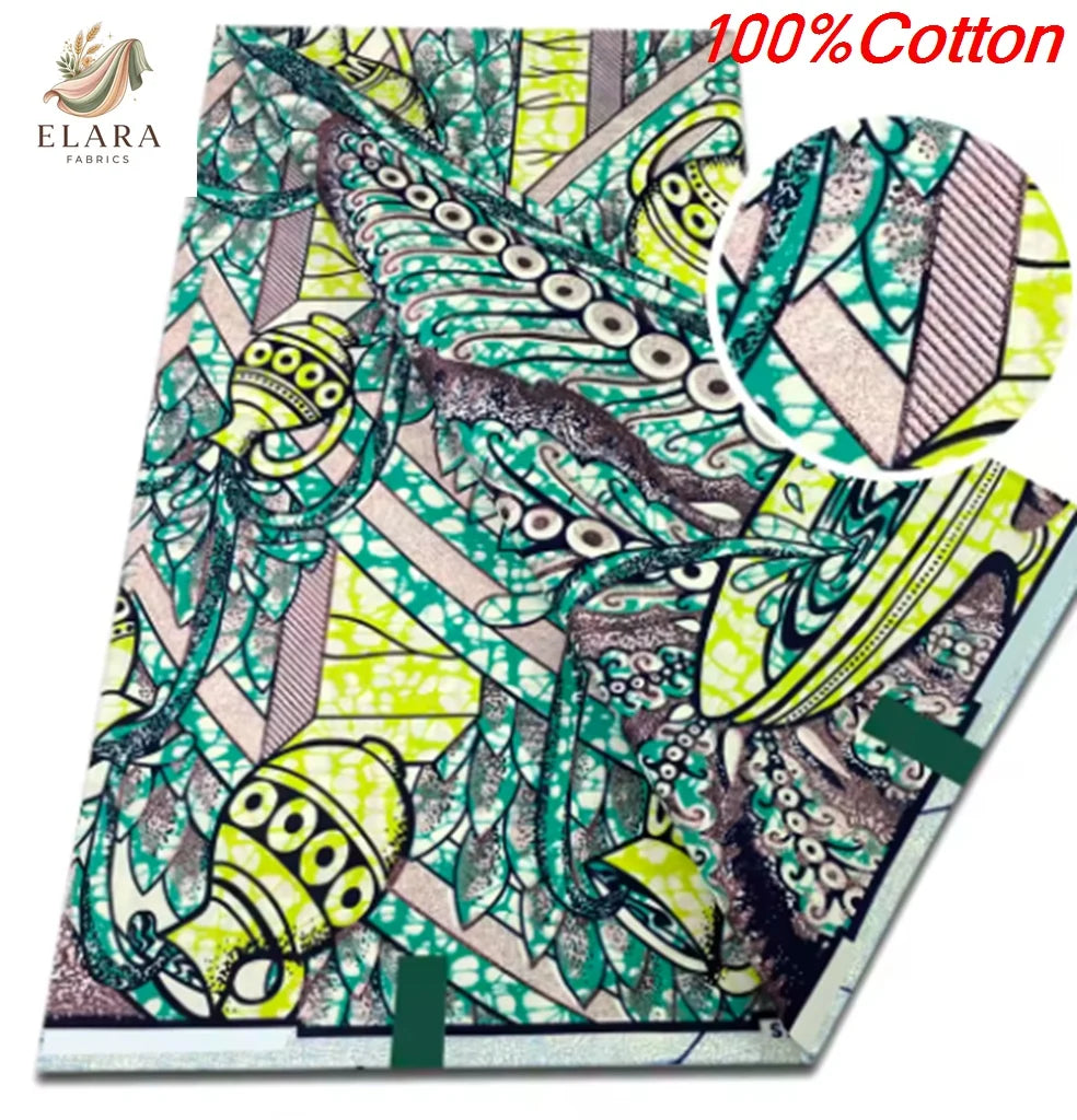 A close-up view of pink glitter African wax print fabric featuring intricate green and beige patterns.