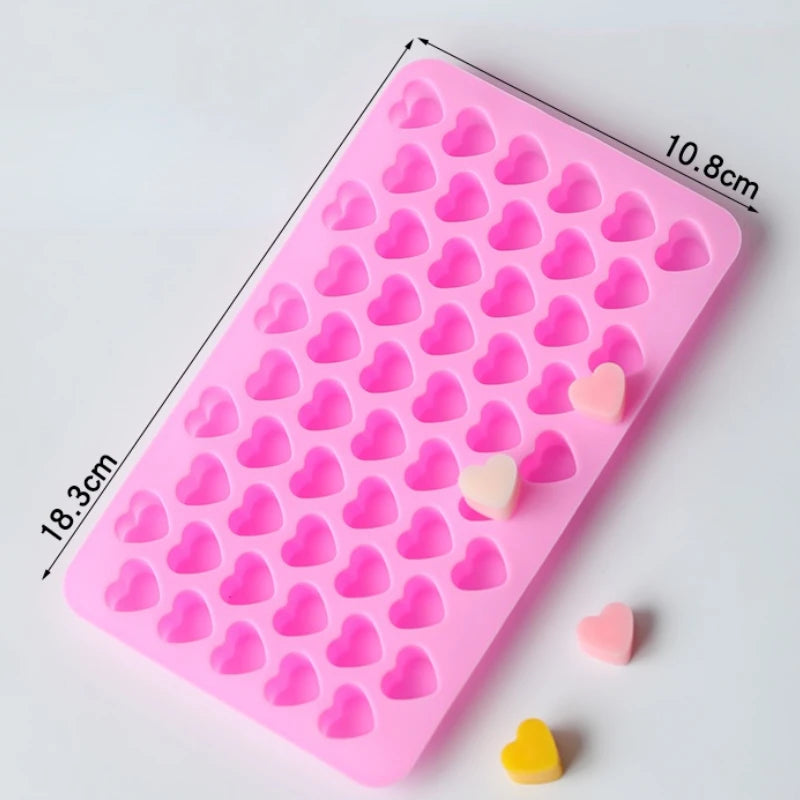 A pink silicone mold with heart-shaped cavities for DIY candles, soap, and chocolate, showing various heart shapes.