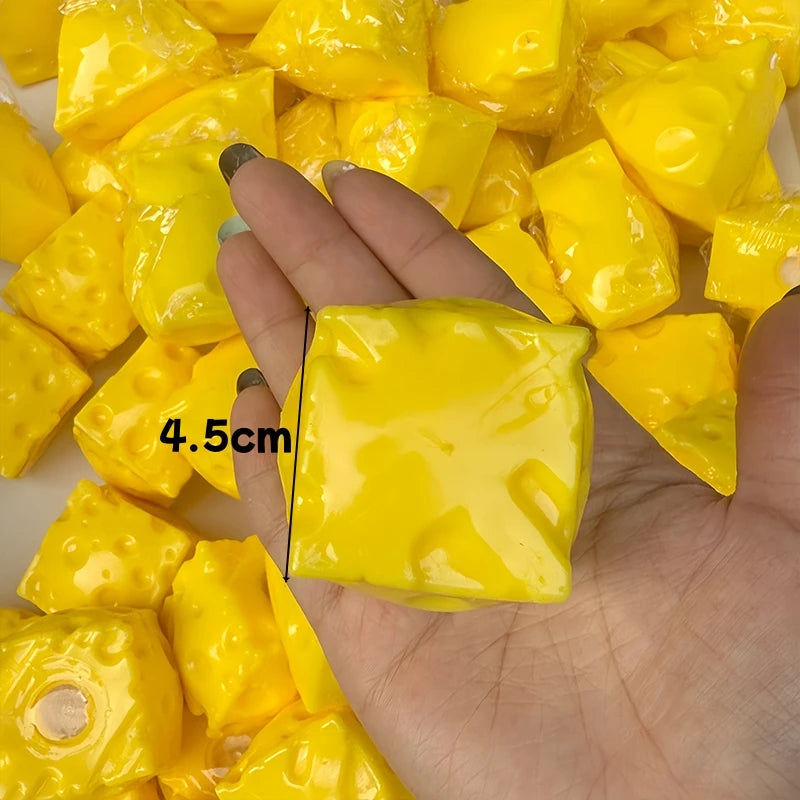 A hand holds several bright yellow, squishy fidget cubes for stress relief.
