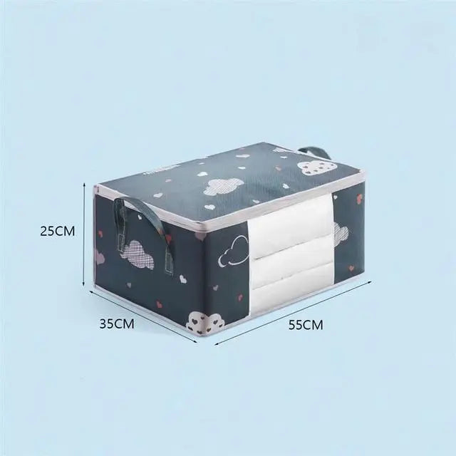 A rectangular storage bag for blankets and clothes with a zipper, featuring a dark gray fabric pattern of white clouds and he