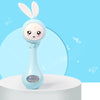 A light blue musical rabbit rattle and teether toy standing on a white surface against a light blue background.