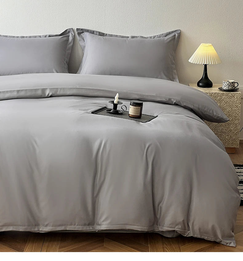 A gray washed cotton brushed duvet cover with matching pillows and bedding on a bed.