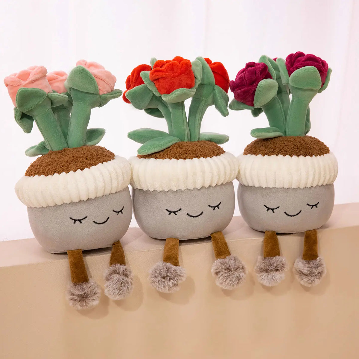 Three cute artificial flower plush dolls with soft green plant decor and fuzzy feet
