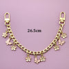 A gold-colored chain necklace featuring small flower charms and butterfly pendants.