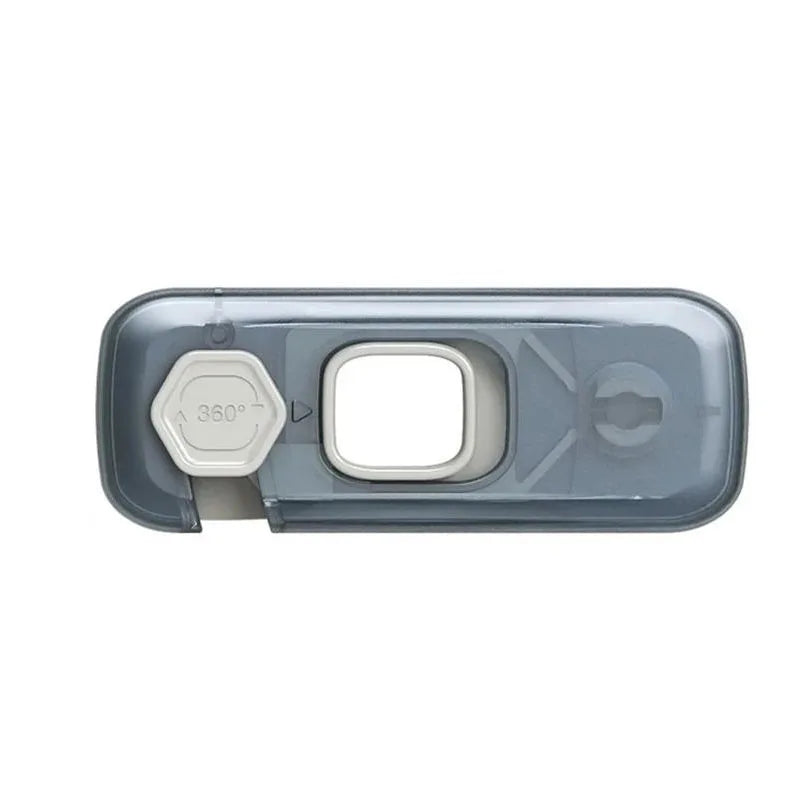 A clear plastic child safety cabinet lock with a hexagonal feature and a rectangular opening.