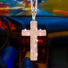 A stainless steel rhinestone cross pendant hanging from a chain, set against a blurred car interior background.