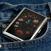 A vintage metal card and cash case with an art deco design is shown inside a denim jean pocket.