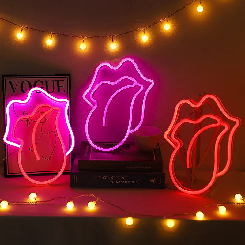 A neon sign shaped like lips glows pink on a dark background with string lights above.