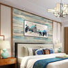 Bedroom featuring a bed with blue bedding against a wall covered in vintage wood grain peel and stick wallpaper.
