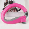 A bright pink ergonomic grocery bag carrier with a soft-grip handle is shown against a white background.