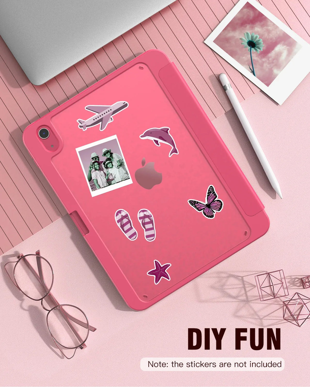 A pink slim tri-fold stand case for an iPad is shown with various decorative stickers and a white pen nearby.