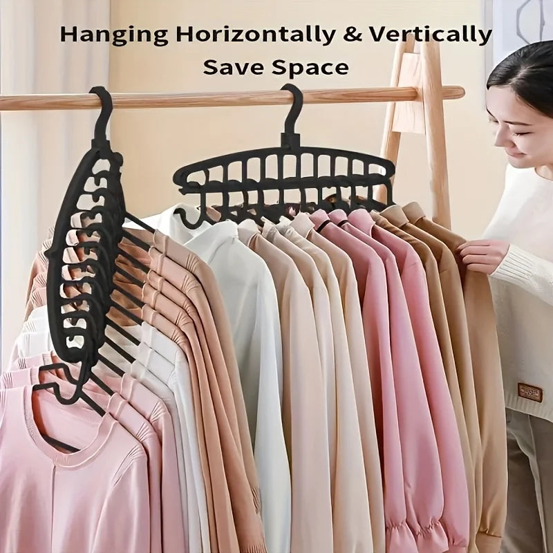 A display of multi-layer space-saving closet hangers hanging horizontally and vertically on a wooden rod.