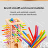 A wooden pick-up sticks board game featuring smooth, round sticks in various colors.