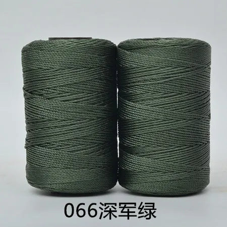 Two spools of dark green 3-ply polyester knitting yarn for crochet and hand crafts