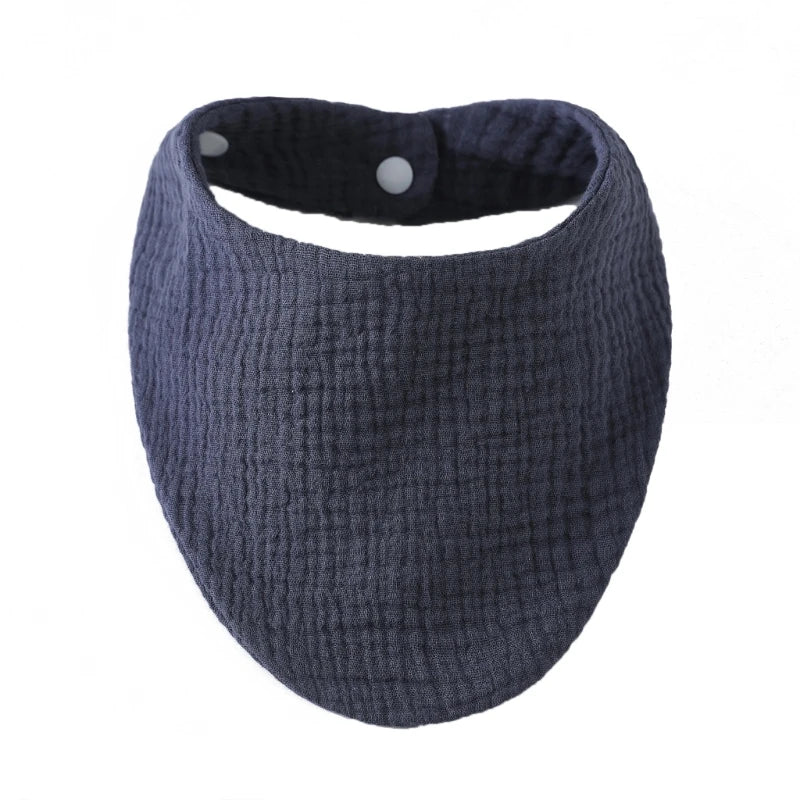 A dark gray knitted baby bib made of organic cotton muslin with an absorbent band around the neck.