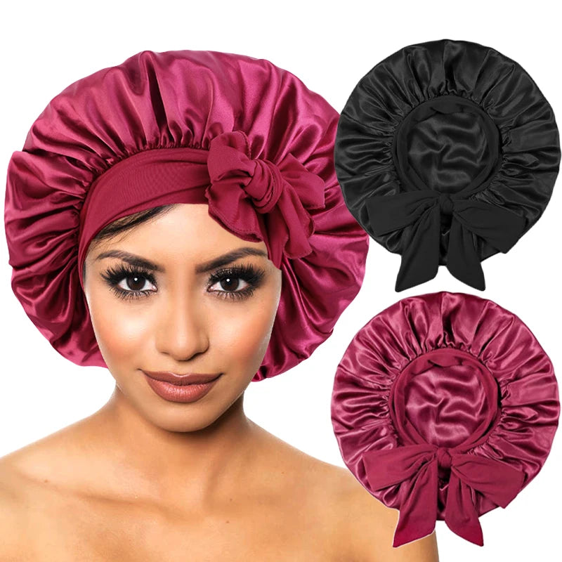 A woman models a deep pink satin sleep cap with a wide band and a large bow, shown alongside the unfastened cap.