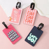 Pink and dark blue silicone luggage tags featuring vacation, ciao, and let's go text