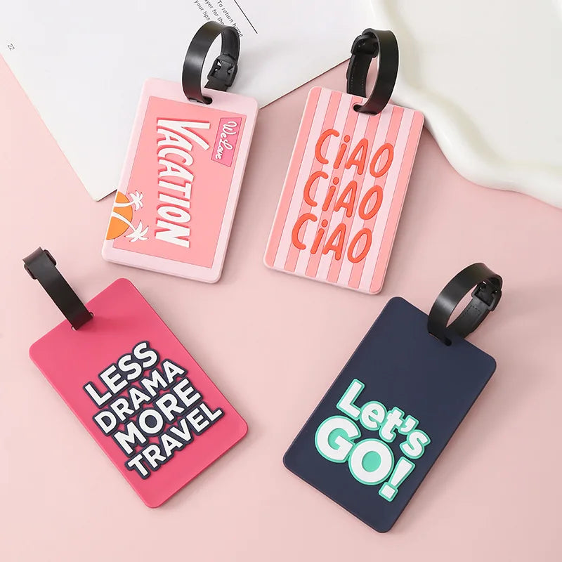 Pink and dark blue silicone luggage tags featuring vacation, ciao, and let's go text