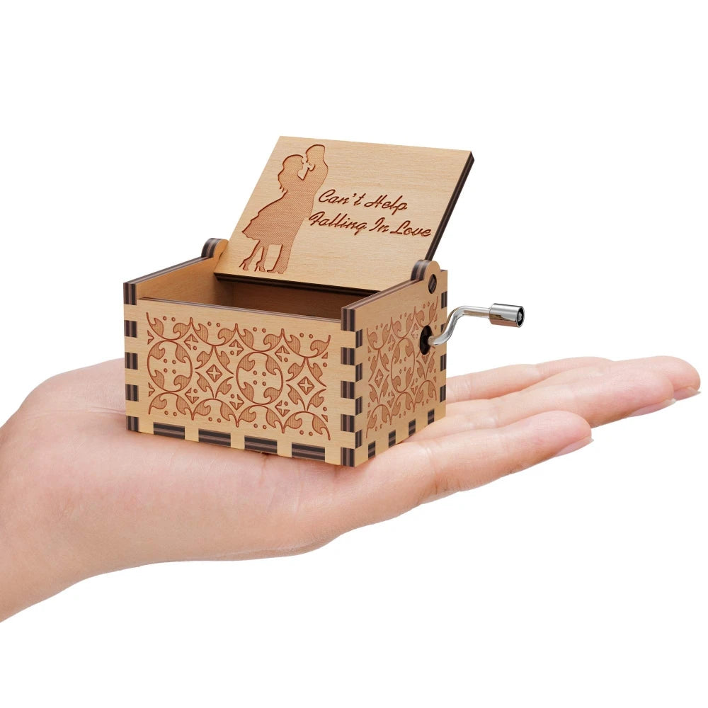 A vintage hand-cranked wooden music box plays "Can't Help Falling in Love" featuring a silhouette of a woman.