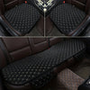 A set of three black quilted car seat covers for universal protection, shown in a dark interior setting.