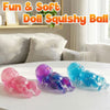 A collection of colorful glitter squishy balls in pink, purple, and blue resting on a white surface.
