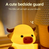 A yellow silicone night light shaped like a calf is shown illuminating a bedside area.