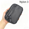 A hand holds a black Nylon 3 utility pouch with a zipper and a small attached loop.