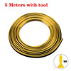 A coil of 5 meters of gold-colored flexible car interior trim strips with a tool.