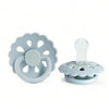 Light blue silicone baby pacifier with a flower-shaped ring and a clear nipple top