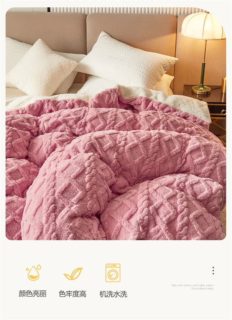 A close-up of a pink textured velvet duvet cover and blanket displayed on a bed.